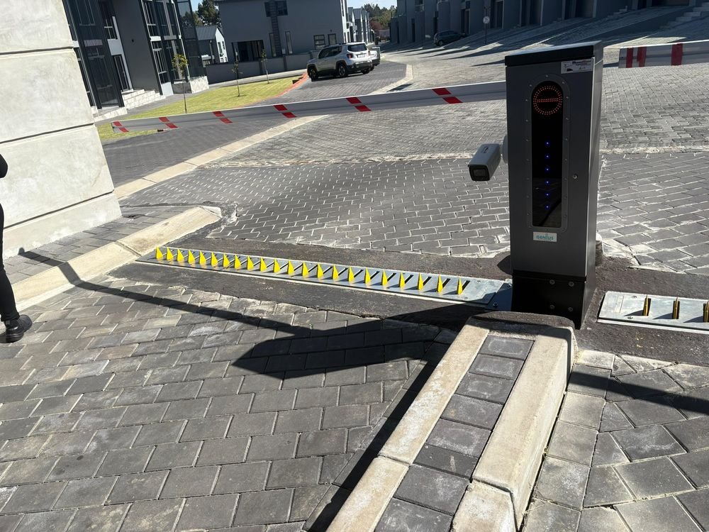 Automated boom gate and spike barrier